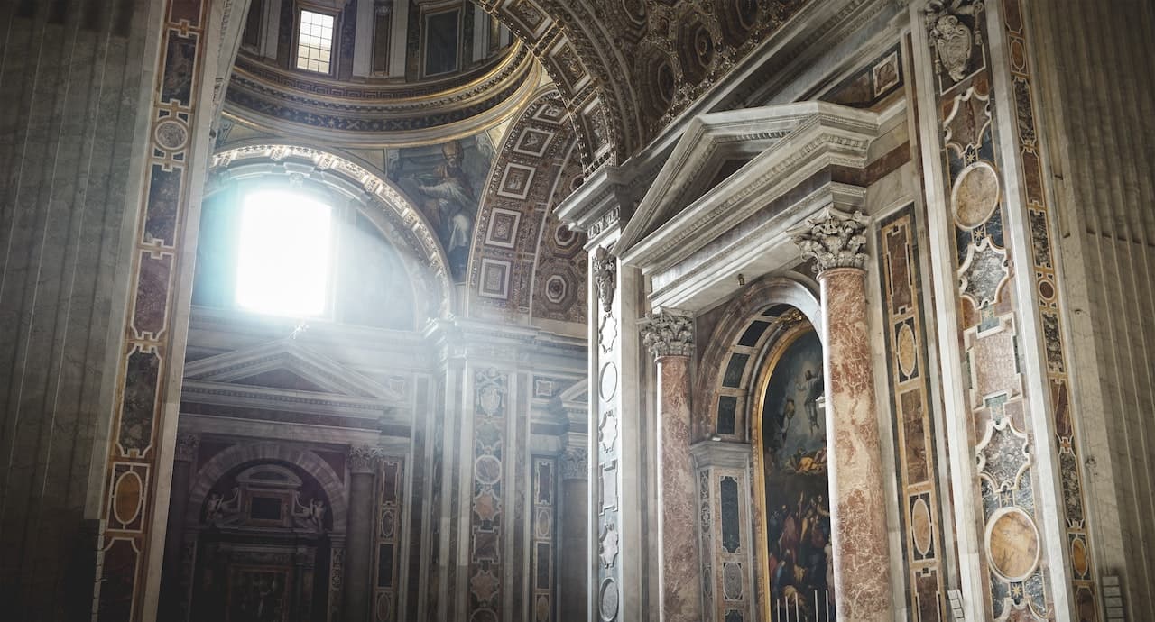 An ancient church with the sun shining in through the window.