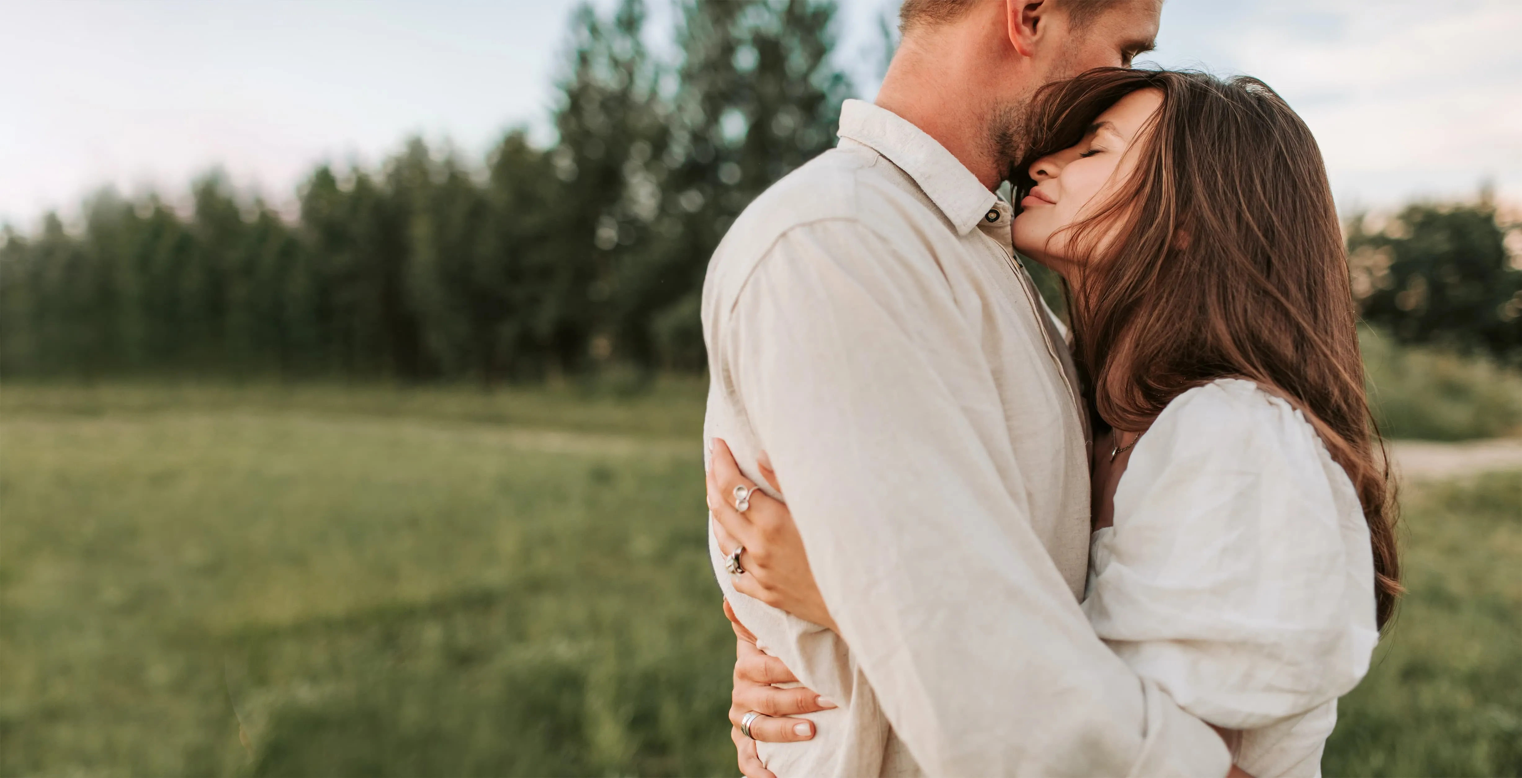 A successful relationship - a happy couple embracing in the park