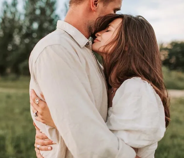 A happy couple embracing in the park
