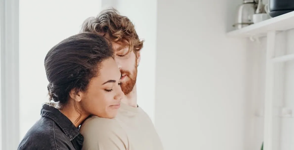 A strong relationship example showing a couple standing in the kitchen cooking together. An example of a happy relationship.