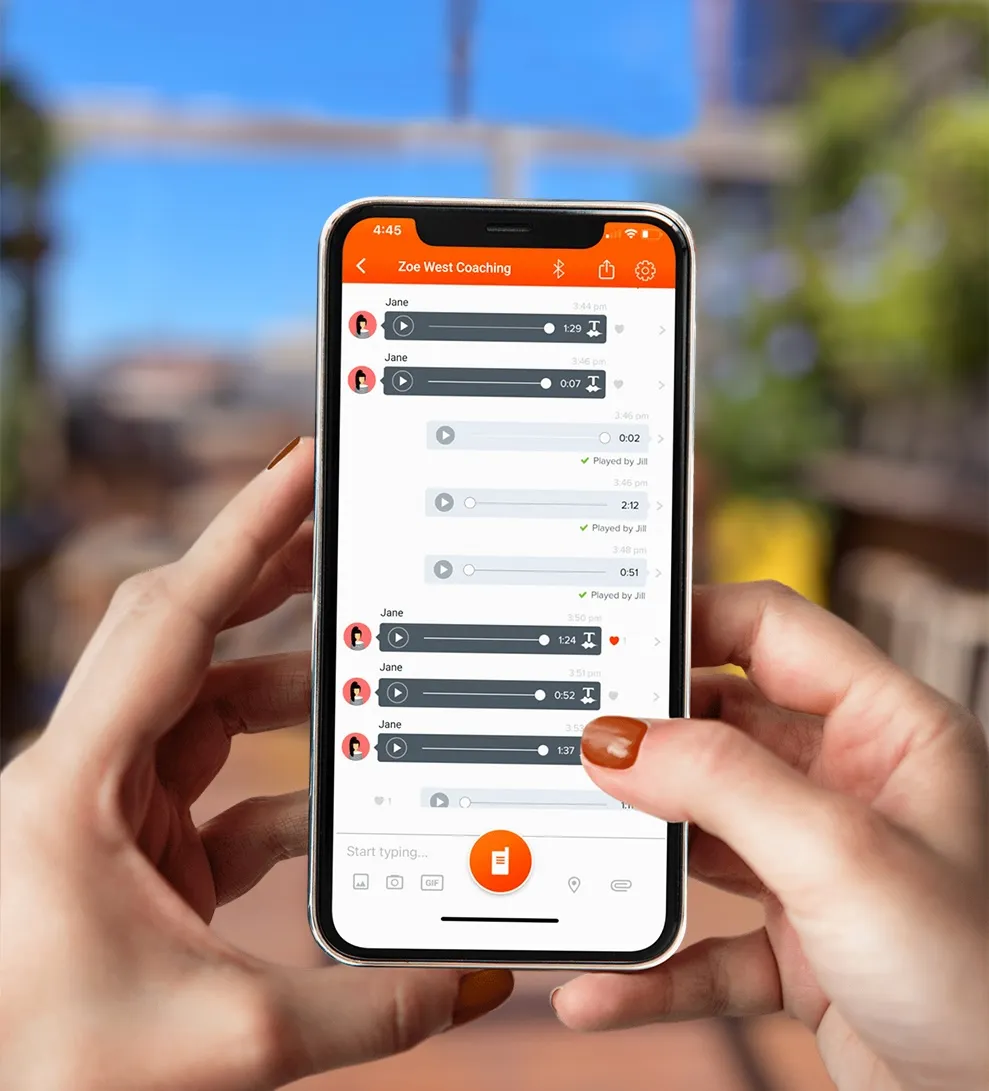 Photo showing the Voxer app open for coaching on a phone held by Zoe West